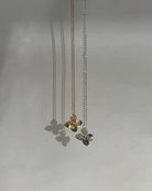 Gold and Silver Hydrangea pendants on thin gold chains against a light gray background